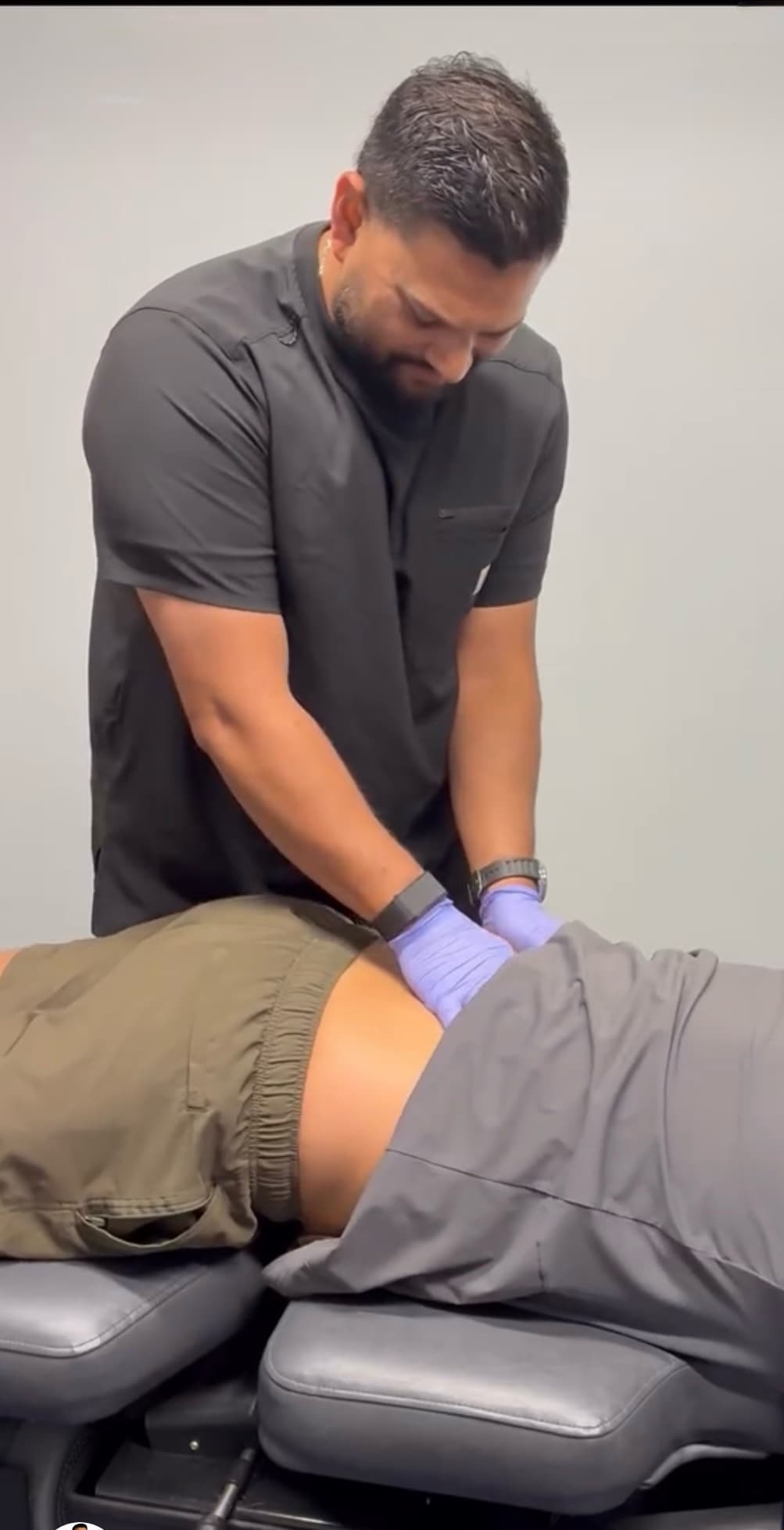 Dr. Tushar Rawalji, DC working one-on-one with a patient at Foundation Chiropractic and Wellness